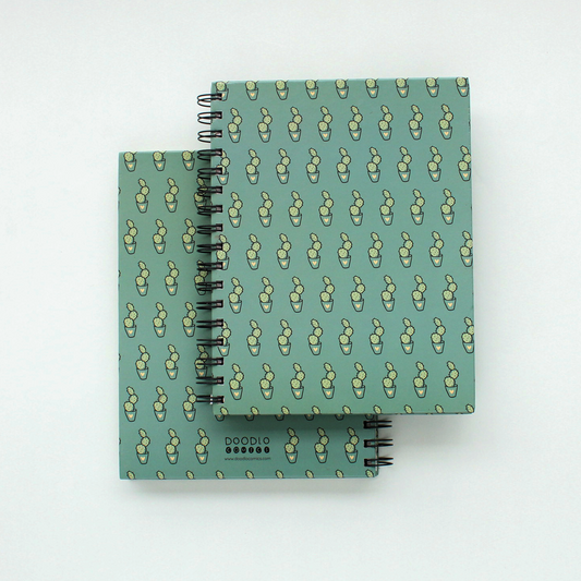 two spiral notebook of cactus doodle stacked upon each other