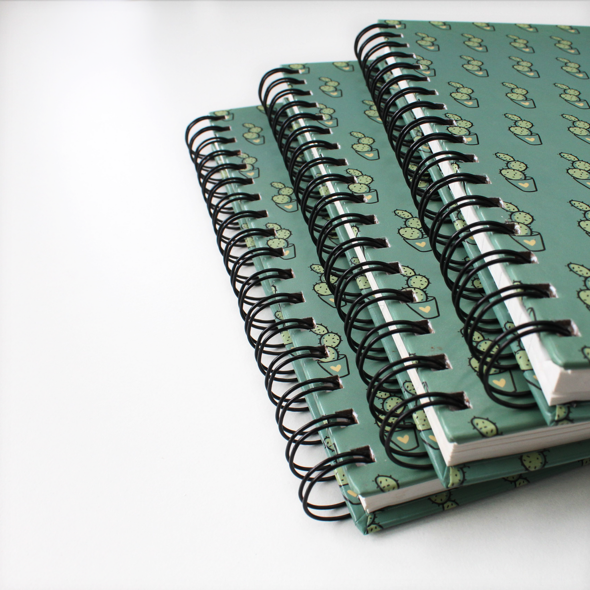3 spiral doodle notebooks stacked upon each other