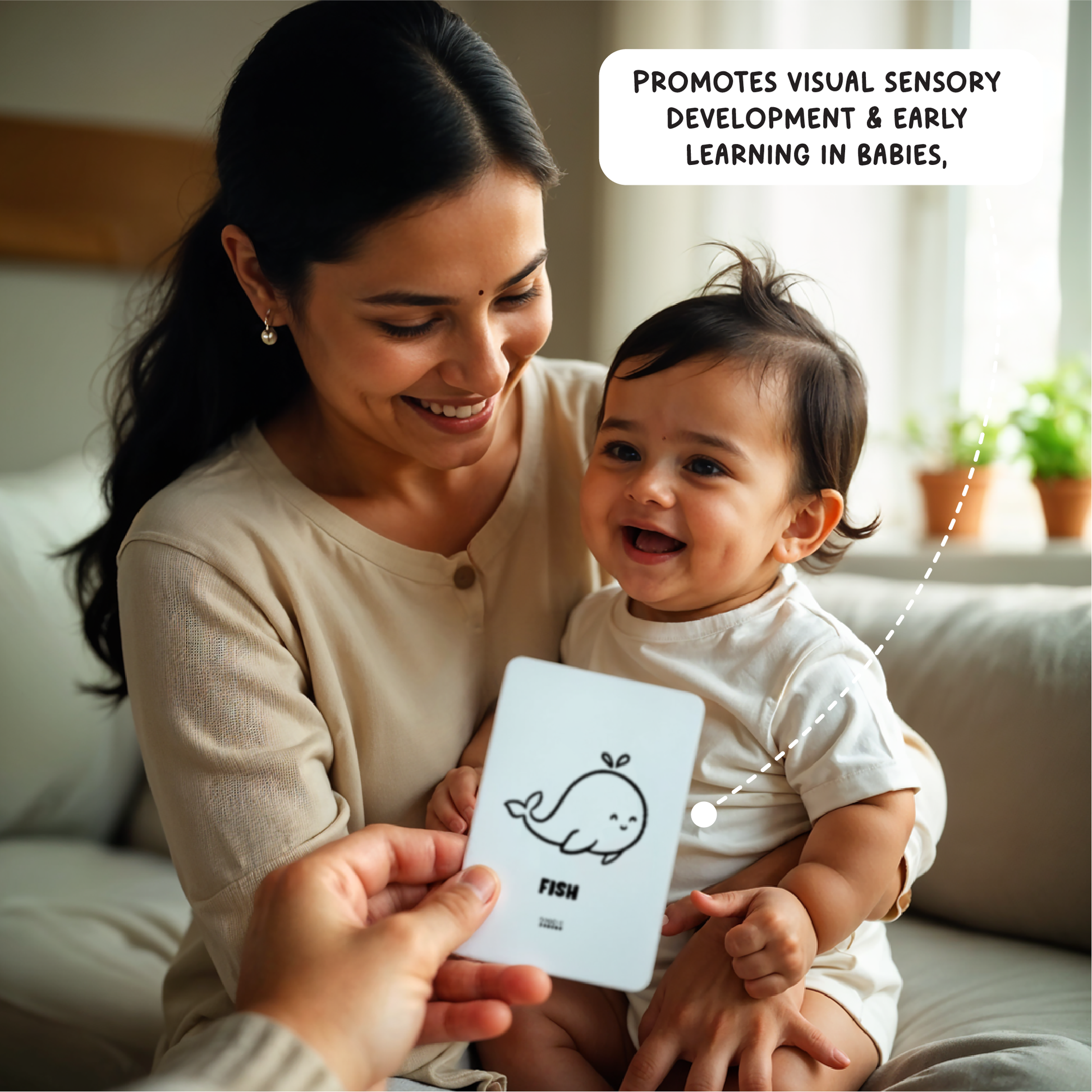 Mom setting on sofa shows a flash card with a fish drawing showing to the baby